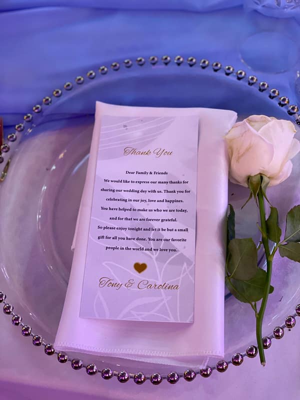 Menu card with a pink rose on a beaded lilac plate